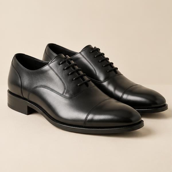 A pair of polished black leather lace-up shoes